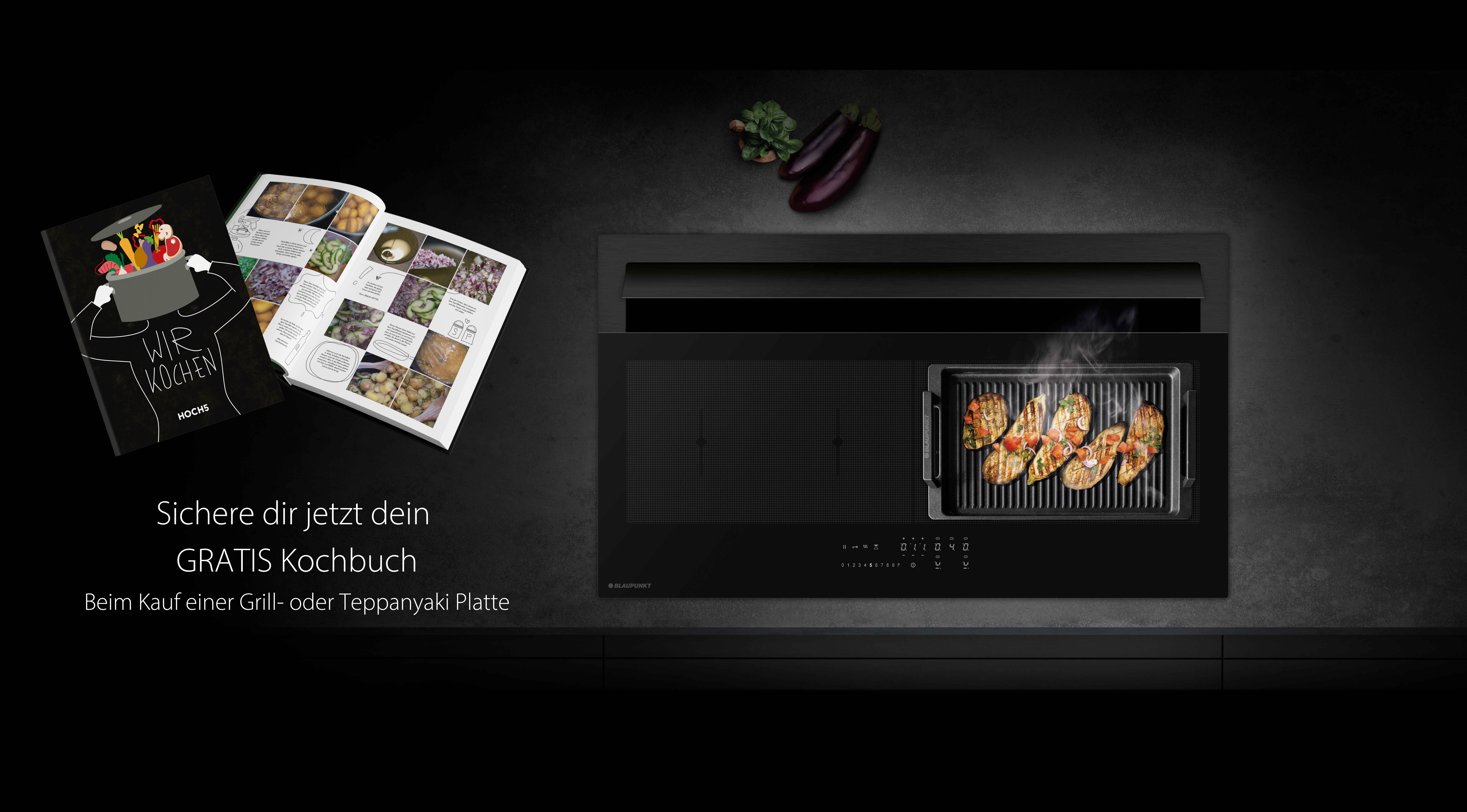Ein Bild einer Teppanyaki Platte mit einem Kochbuch daneben